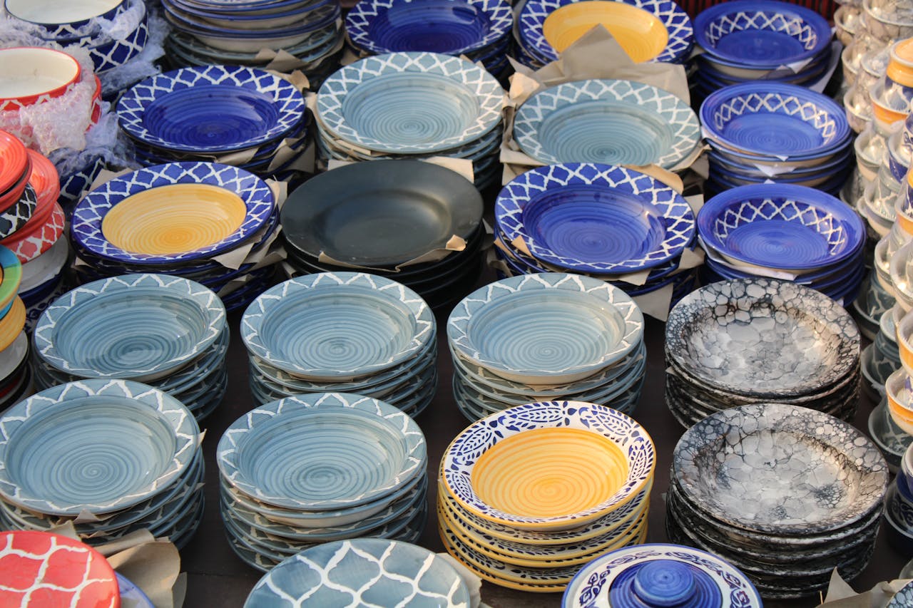 home-hero Brightly colored ceramic plates stacked on display, showcasing intricate designs.